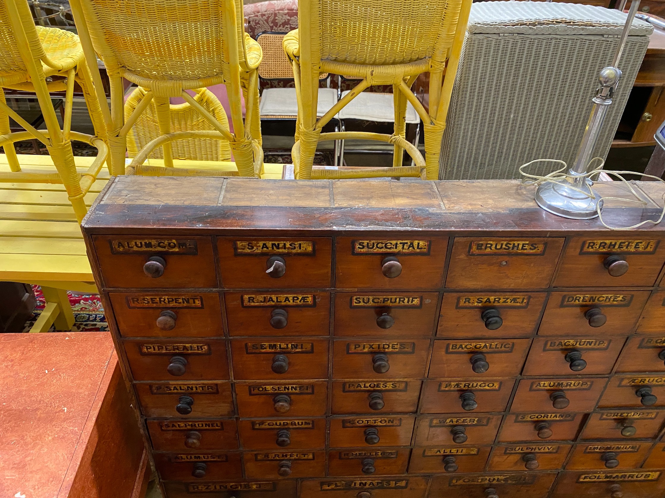 A 19th century mahogany and pine 66 drawer apothecary chest with turned wood handles and some later painted detail, length 227cm, depth 20cm, height 102cm